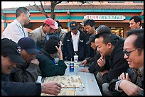 Vietnamese immigrants at a Chinese chess game. San Jose, California, USA (color)