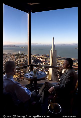 Businessmen with a bottle of Champagne in the Carnelian Room with panoramic view of the City. San Francisco, California, USA (color)