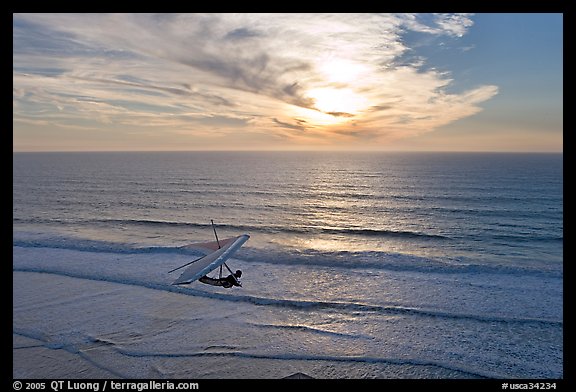 Hang glider flying  above ocean, Fort Funston, sunset. San Francisco, California, USA