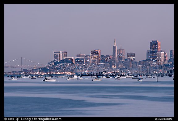 Harbor in Richardson Bay with houseboats and city skyline at dusk. San Francisco, California, USA