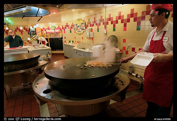 Cook preparing Mongolian BBQ, Horton Plaza. San Diego, California, USA (color)