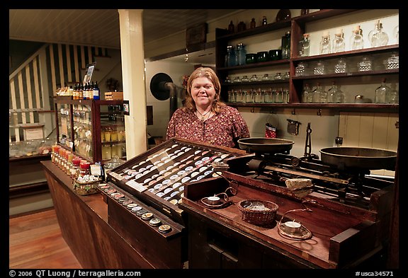 Woman standing behind counter of apothicary store, Old Town. San Diego, California, USA (color)