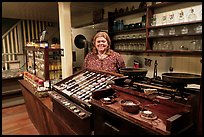 Woman standing behind counter of apothicary store, Old Town. San Diego, California, USA ( color)