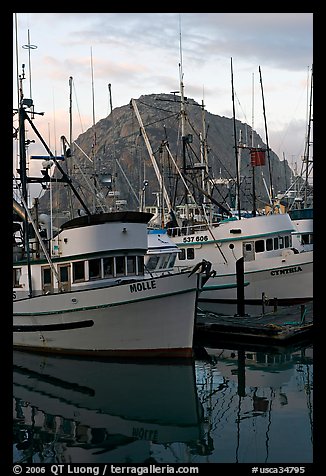 Fishing boats and Morro Rock, sunrise. Morro Bay, USA