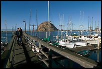 People walking on a deck in the harbor. Morro Bay, USA (color)