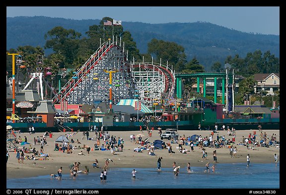 Beachgoers, and Santa Cruz boardwalk roller-coaster. Santa Cruz, California, USA