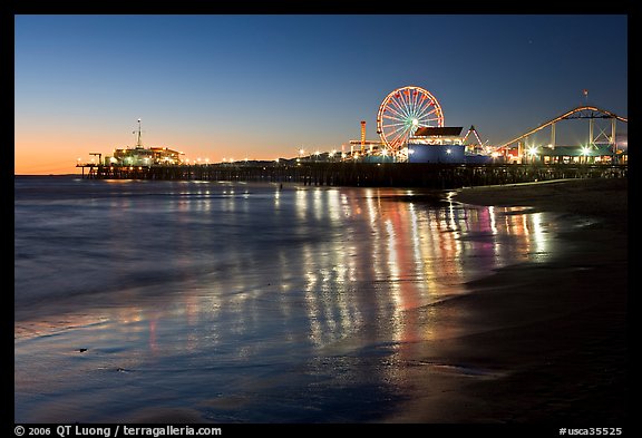 Pier and Ferris Wheel reflected on beach at dusk. Santa Monica, Los Angeles, California, USA
