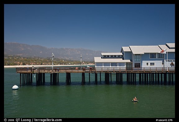 Man on buoy and pier. Santa Barbara, California, USA