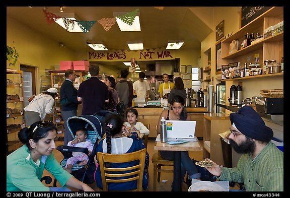 Indian family inside popular pizza restaurant, Haight-Ashbury district. San Francisco, California, USA (color)