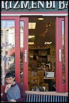 Man biting pizza outside pizzaria, Haight-Ashbury district. San Francisco, California, USA (color)