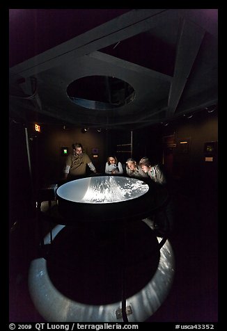 Tourists look at moving image of ocean inside the Camera Obscura, Cliff House. San Francisco, California, USA (color)