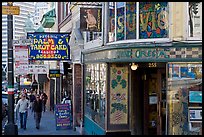 Sidewalk with Vesuvio Cafe, Jack Kerouac street sign, Columbus Tower, and Transamerica Pyramid, North Beach. San Francisco, California, USA (color)