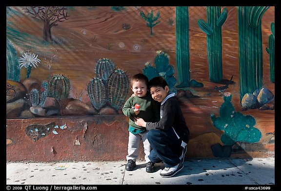 Boys and mural, Mission District. San Francisco, California, USA