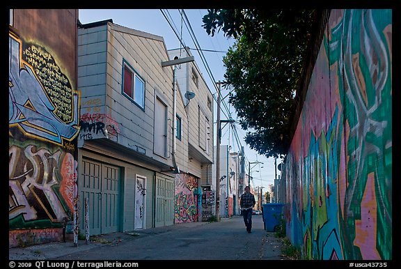 Man walking in alley, Mission District. San Francisco, California, USA