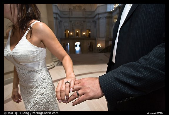 Newly wed couple holds hands, showing ring, City Hall. San Francisco, California, USA (color)