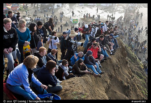 Spectators sitting on cliff to see mavericks contest. Half Moon Bay, California, USA