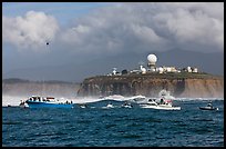 Flottila of boats near Mavericks break in front of Pillar Point radar station. Half Moon Bay, California, USA (color)