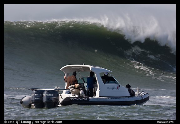 Small boat dwarfed by huge wave. Half Moon Bay, California, USA