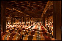 Barrels of wine in wine cellar. Napa Valley, California, USA (color)