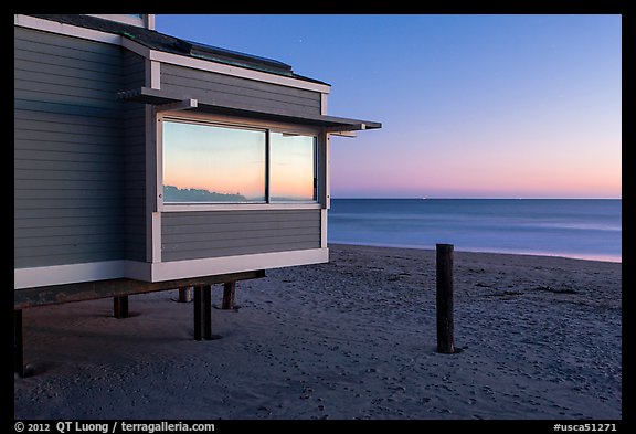 Modern beach house with large window reflecting sunset, Stinson Beach. California, USA