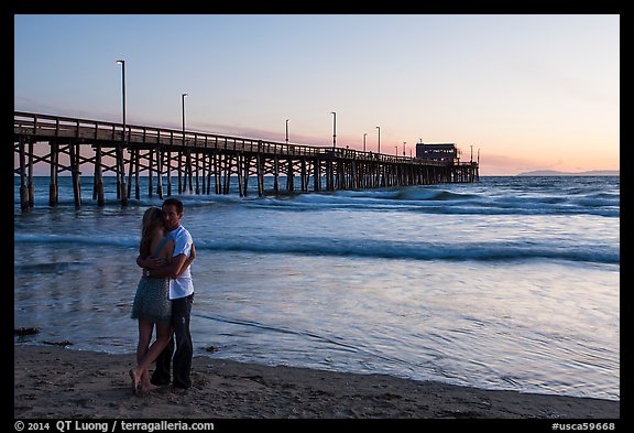 Couple embracing in front of Newport Pier. Newport Beach, Orange County, California, USA (color)