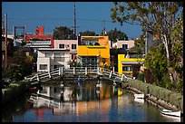 Rower under bridge next to colorful houses. Venice, Los Angeles, California, USA ( color)