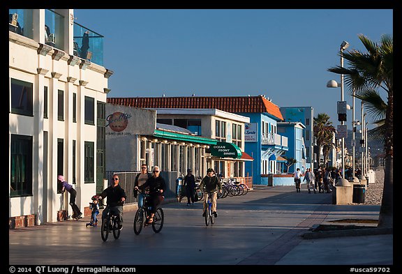 Riding bicycles on beachfront promenade, Hermosa Beach. Los Angeles, California, USA (color)