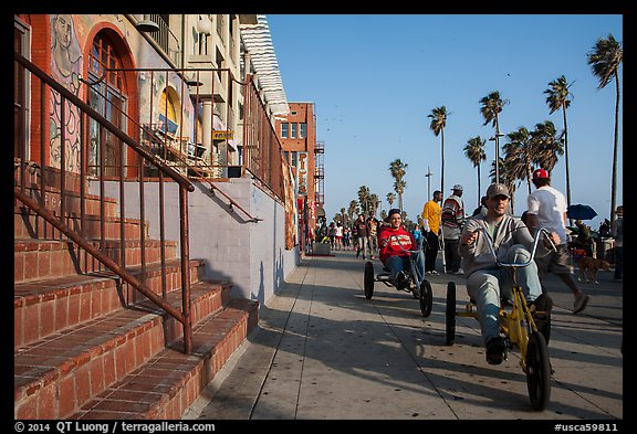 Men riding tricycles on Ocean Front Walk. Venice, Los Angeles, California, USA (color)
