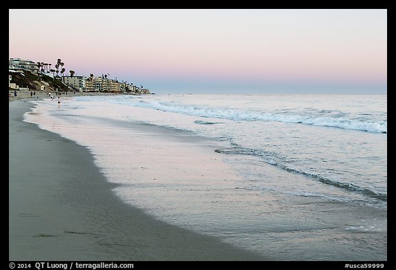 Beach at sunset with colors of sky reflected in wet sand. Laguna Beach, Orange County, California, USA (color)