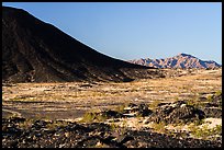 Lava field, Amboy Crater slope and mountains. Mojave Trails National Monument, California, USA ( color)