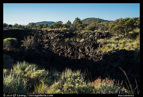 Lava depression and distant buttes. Lava Beds National Monument, California, USA