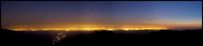 Central Valley lights at dusk seen from Morro Rock. California, USA (Panoramic color)
