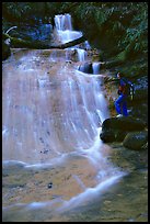 Golden cascade and hiker. Big Basin Redwoods State Park,  California, USA