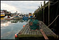 Lobster traps and fishing boats below pier. Portland, Maine, USA