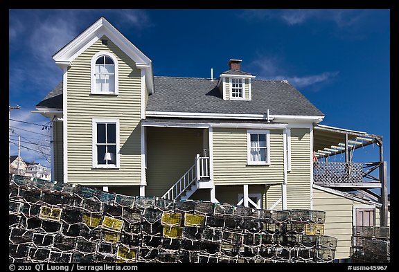 Lobster traps lined in front of house. Stonington, Maine, USA (color)