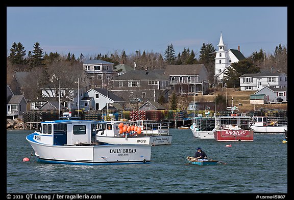 Lobsterman paddling towards boat. Corea, Maine, USA (color)