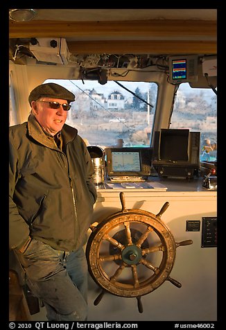 Captain of Isle-au-Haut mailboat aboard boat. Isle Au Haut, Maine, USA