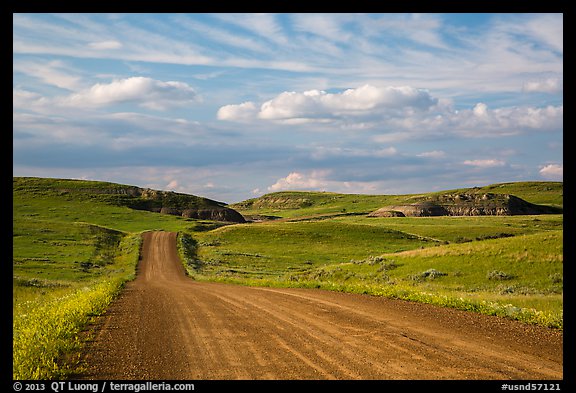 Gravel road, rolling hills and badlands. North Dakota, USA (color)