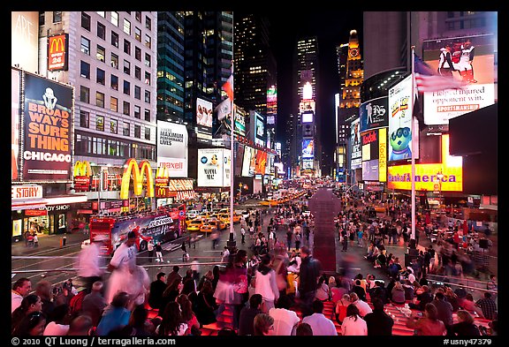 Crowds on Times Squares at night. NYC, New York, USA