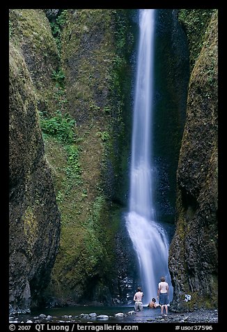 Men soaking at the base of Oneonta Falls. Columbia River Gorge, Oregon, USA