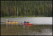 Parents kayaking with children in tow, Devils Lake. Oregon, USA (color)