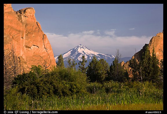 Snow-capped volcano seen between rock pinnacles. Smith Rock State Park, Oregon, USA