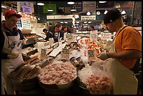 Countermen unloading seafood,  Pike Place Market. Seattle, Washington
