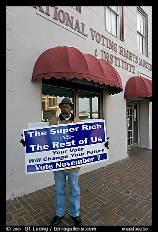 African-American man holding a voting sign in front of the voting rights museum. Selma, Alabama, USA (color)