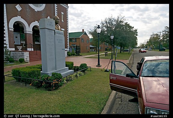 African-American man sitting in car looking at Martin Luther King memorial. Selma, Alabama, USA (color)