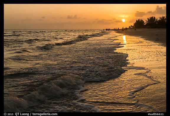 Beach with people in the distance at sunset, Sanibel Island. Florida, USA