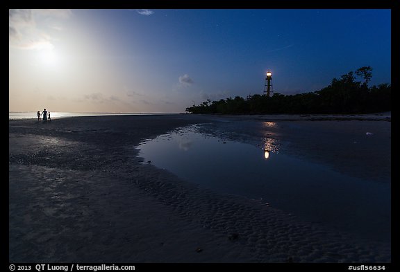 Lighthouse beach with family in distance and moonlight, Sanibel Island. Florida, USA