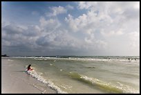 Woman sitting in water, Fort De Soto beach. Florida, USA ( color)