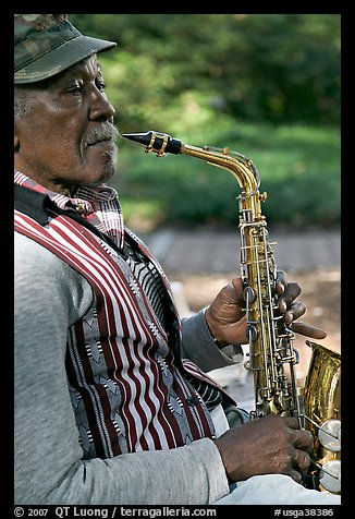 African-American musician with saxophone in square. Savannah, Georgia, USA (color)