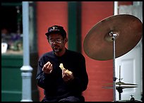 Street musician taking a lunch break, French Quarter. New Orleans, Louisiana, USA (color)